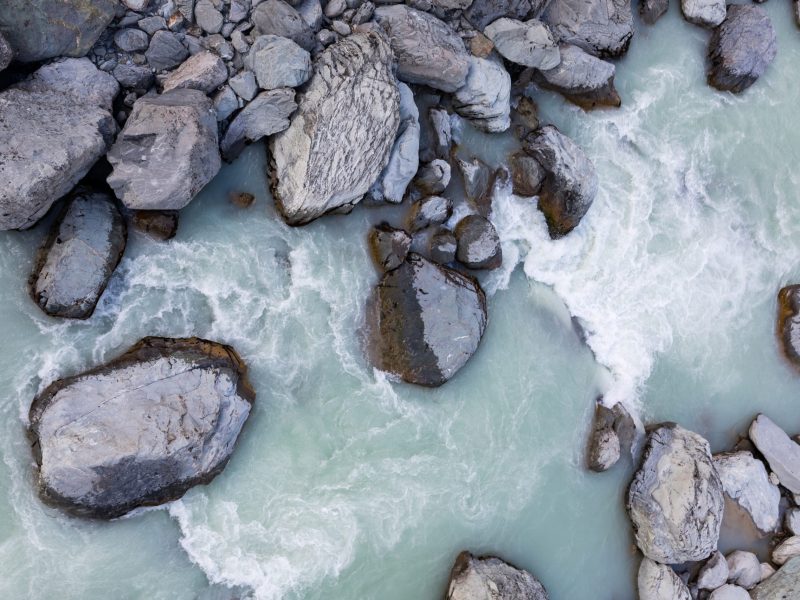 Overhead view of alpine rocks and stream with glacial water, Mount Cook Aoraki National Park, New Zealand
